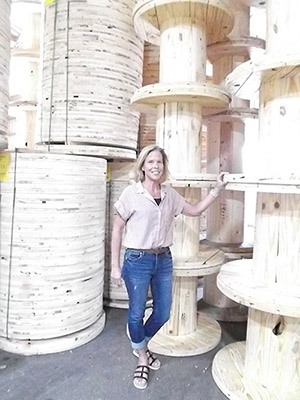 Lori Standing with wooden reels