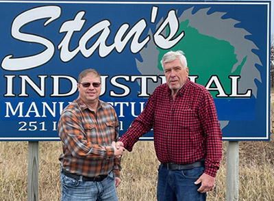 pic of Troy and George standing in front of Stan's Industrial Manufacturing sign